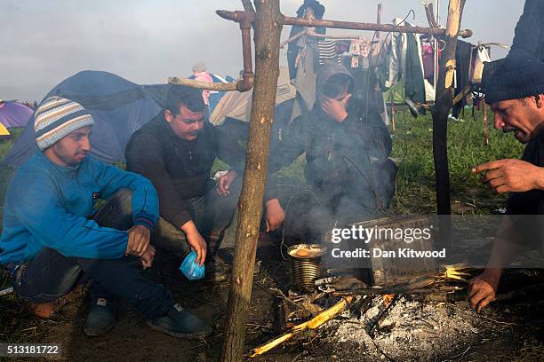 Men gather around a fire at the Greek-Macedonia border on March 01, 2016 near Idomeni, Greece. The transit camp has become overcrowded as refugees...