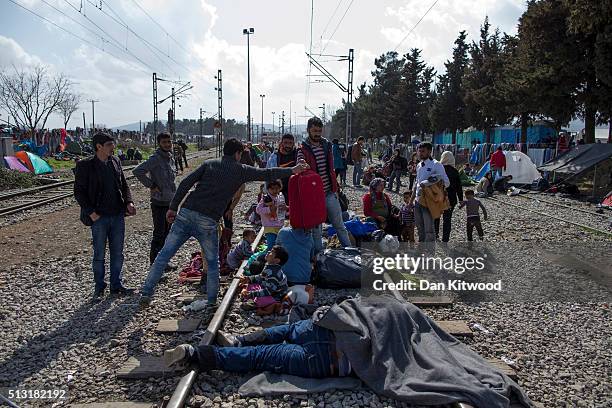 Families gather on train tracks as refugees continue to arrive at the Greek-Macedonia border on March 01, 2016 near Idomeni, Greece. The transit camp...