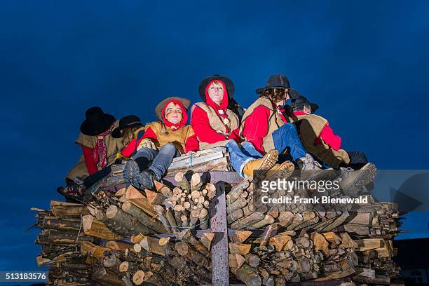 The Chienbäse is part of the Basler Fasnacht, people are sitting on carriers loaded with wood which will be lit and taken through the streets in the...