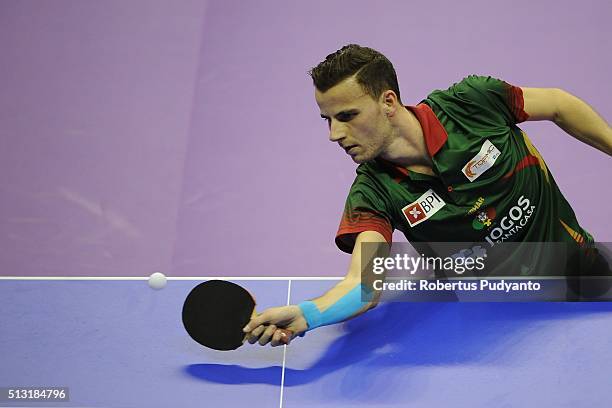 Tiago Apolonia of Portugal competes against Jakub Dyjas of Poland during the 2016 World Table Tennis Championship Men's Team Division Round 4 match...