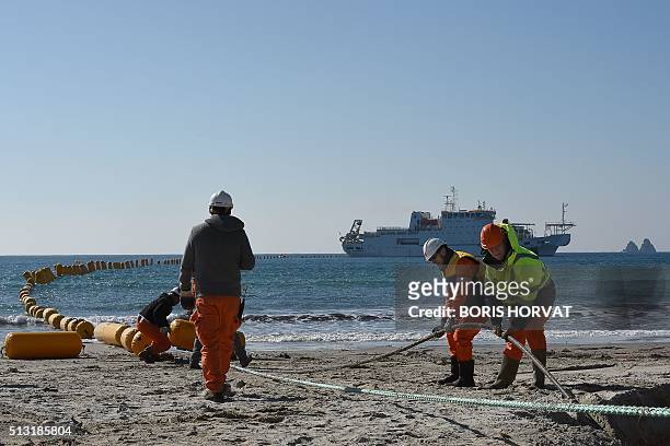 Employees of Orange Marine work on the installation of the very high speed submarine cable "SEA-ME-WE 5" linking Singapore to France, on March 1,...