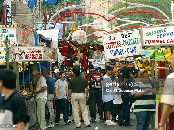 People attend the annual Feast of San Gennaro festival September 17, 2004 in New York City. The annual Italian festival has taken place every...