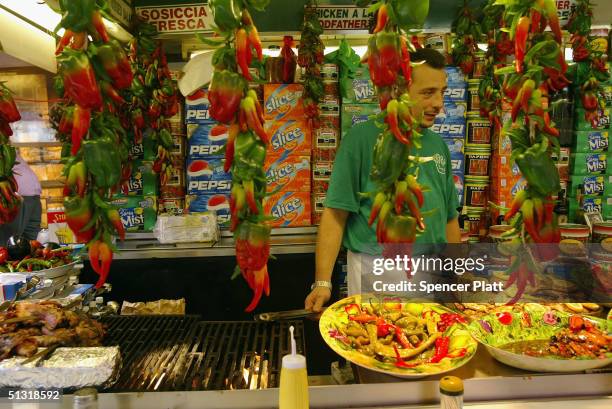Man prepares a traditional Italian sausage dish at the annual Feast of San Gennaro festival September 17, 2004 in New York City. The annual Italian...