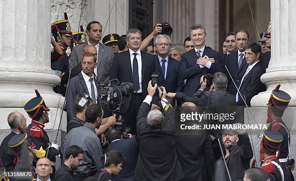Argentine President Mauricio Macri gestures at supporters after the inauguration of the 134th period of ordinary sessions at the Congress in Buenos...