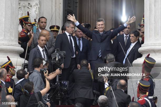 Argentine President Mauricio Macri waves at supporters after the inauguration of the 134th period of ordinary sessions at the Congress in Buenos...