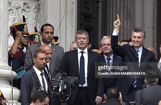 Argentine President Mauricio Macri waves at supporters after the inauguration of the 134th period of ordinary sessions at the Congress in Buenos...