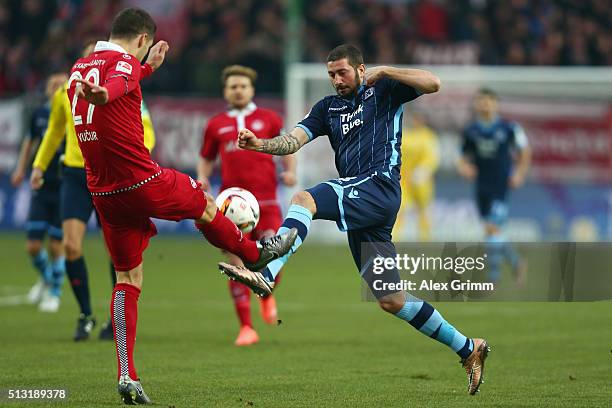 Sascha Moelders of 1860 Muenchen is challenged by Stipe Vucur of Kaiserslautern during the Second Bundesliga match between 1. FC Kaiserslautern and...