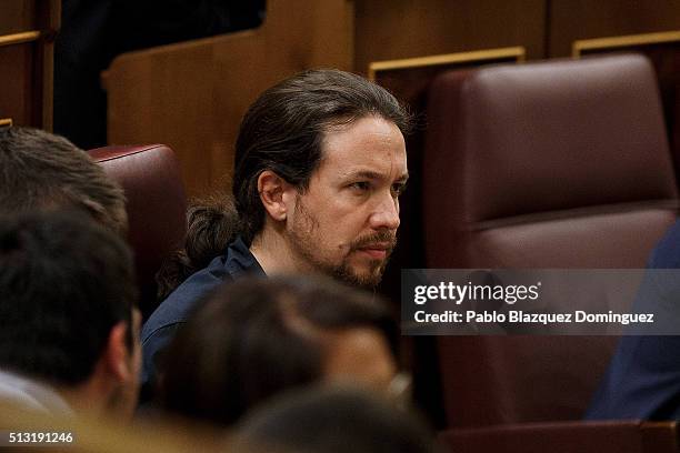 Podemos party leader Pablo Iglesias listens the speech of Spanish Socialist Party leader Pedro Sanchez, during a debate to form a new government at...