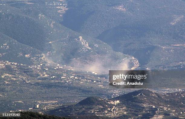 Photo taken from the Hatay province of Turkey shows that smoke rises after Syrian regime forces attacked villages at Jabal al-Akrad province in...