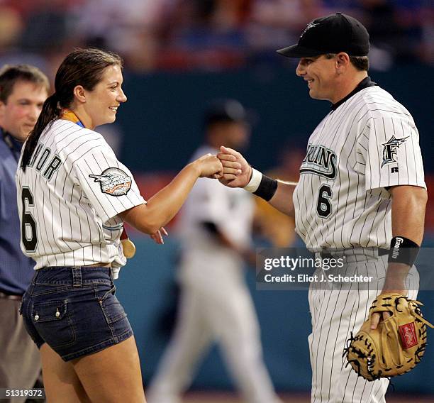 Olympic Gold Medalist in Beach Volleyball, Misty May, is greeted by her fiancee, Matt Treanor of the Florida Marlins, after throwing the ritual first...