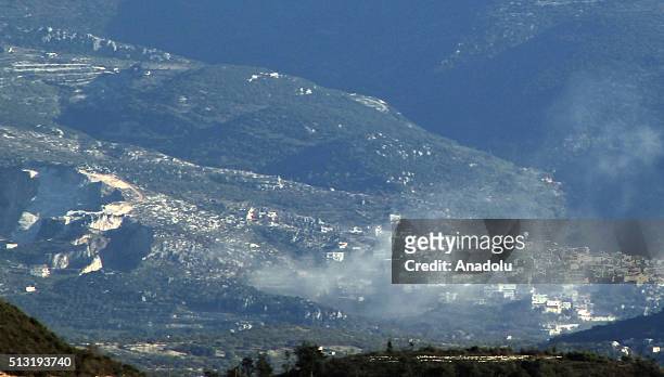 Photo taken from the Hatay province of Turkey shows that smoke rises after Syrian regime forces attacked villages at Jabal al-Akrad province in...