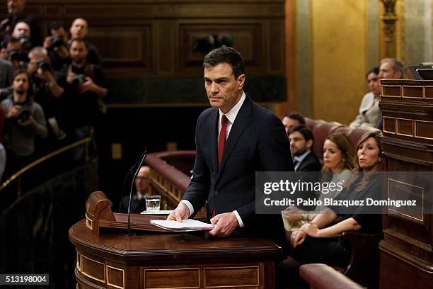 Spanish Socialist Party leader Pedro Sanchez, holds papers as he finishes his speech during a debate to form a new government at the Spanish...