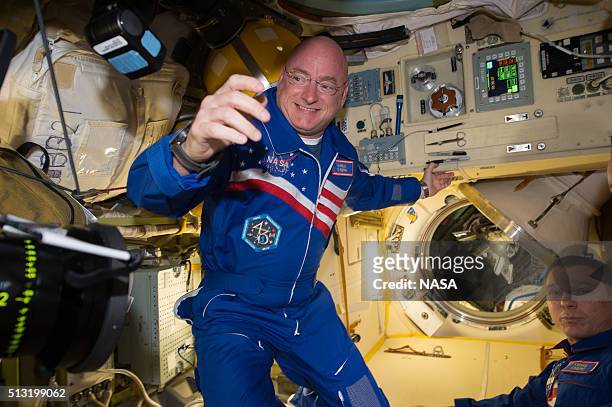 In this handout photo provided by NASA, NASA astronaut Scott Kelly reacts to being aboard the International Space Station after the hatch opening of...
