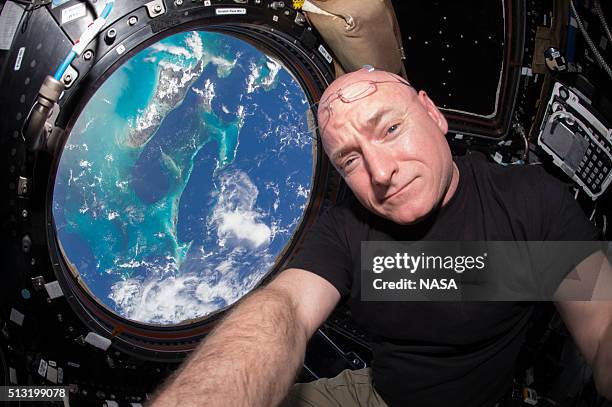 In this handout photo provided by NASA, Expedition 44 flight engineer and NASA astronaut Scott Kelly is seen inside the Cupola, a special module...