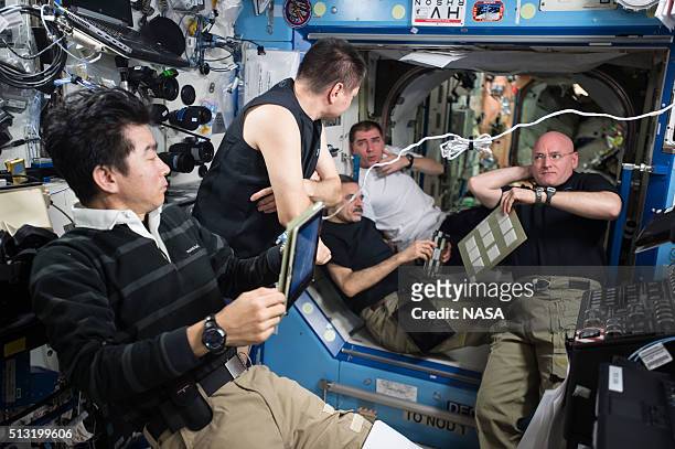 In this handout photo provided by NASA, the Expedition 45 crew aboard the International Space Station gather for an emergency situation simulation...