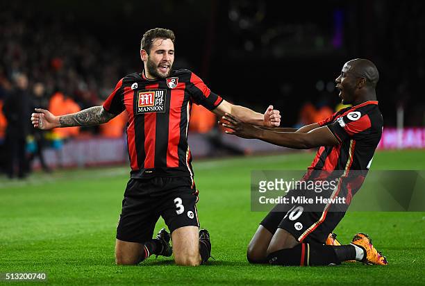 Steve Cook of Bournemouth celebrates scoring his team's first goal with his team mate Benik Afobe during the Barclays Premier League match between...
