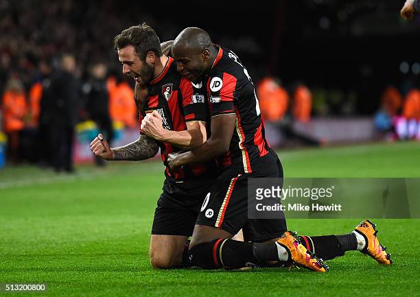 Steve Cook of Bournemouth celebrates scoring his team's first goal with his team mate Benik Afobe during the Barclays Premier League match between...