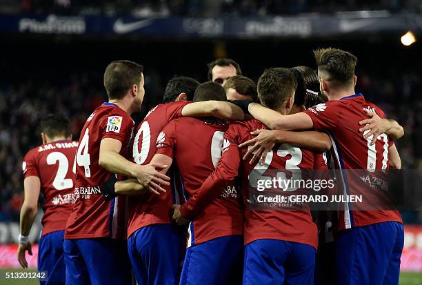 Atletico Madrid's players celebrate after a goal during the Spanish league football match Club Atletico de Madrid vs Real Sociedad de Futbol at the...