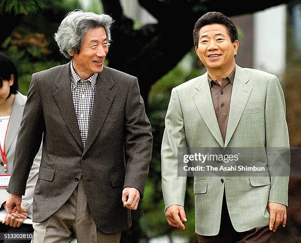 South Korean President Roh Moo Hyun and Japanese Prime Minister Junichiro Koizumi stroll a garden on December 18, 2004 in Ibusuki, Kagoshima, Japan.