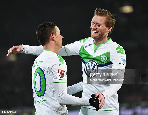 Julian Draxler celebrates scoring the fourth goal with André Schürrle of Wolfsburg during the Bundesliga match between Hannover 96 and VfL Wolfsburg...