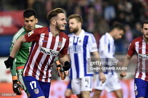 Atletico Madrid's midfielder Saul Niguez celebrates after scoring during the Spanish league football match Club Atletico de Madrid vs Real Sociedad...