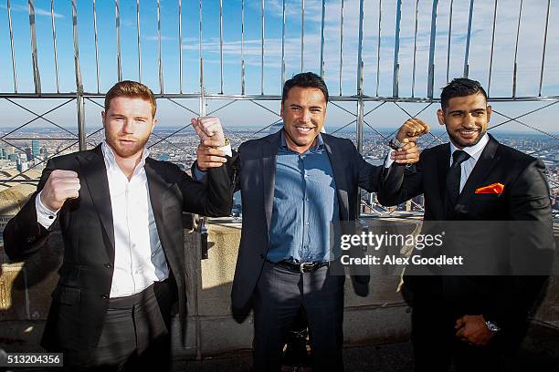 Oscar De La Hoya poses for photos with Canelo Alvarez and Amir Khan during a press event at the Empire State Building on March 1, 2016 in New York...