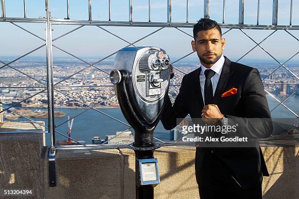 Amir Khan poses for photos during a press event to promote his fight against Canelo Alvarez at the Empire State Building on March 1, 2016 in New York...