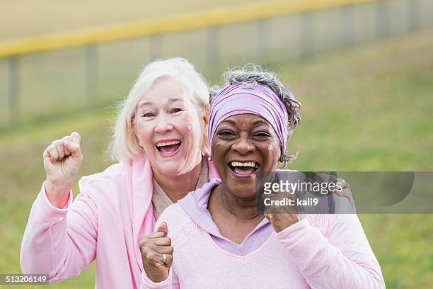 senior women in pink - human rights stock pictures, royalty-free photos & images