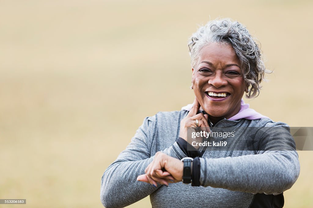 Senior woman exercising, taking pulse
