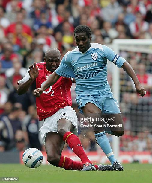 Jay-Jay Okocha of Bolton Wanderers battles for the ball with Patrick Vieira of Arsenal during the Barclays Premiership match between Arsenal and...