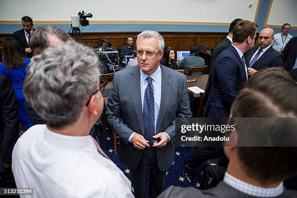 Apples General Council Bruce Sewell talks with colleagues in the chambers before testifying at a House Judiciary Committee Hearing on Apple's denial...