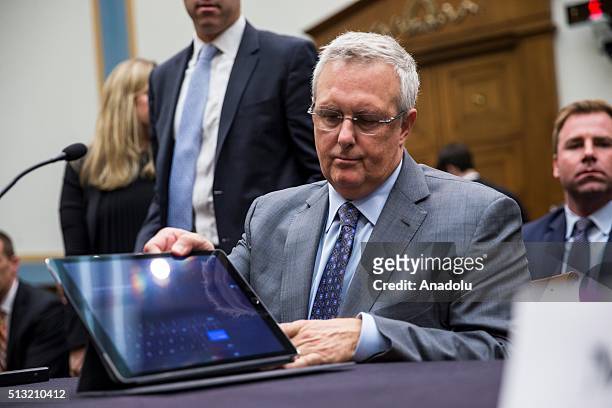 Apples General Council Bruce Sewell sets up an iPad Pro before testifying before a House Judiciary Committee Hearing on Apple's denial of the FBI's...
