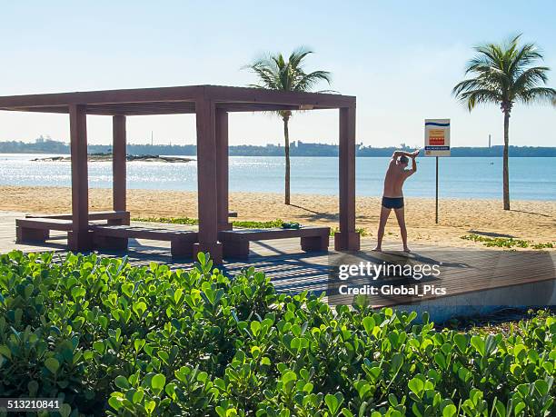 man exercising - old man in speedo stockfoto's en -beelden