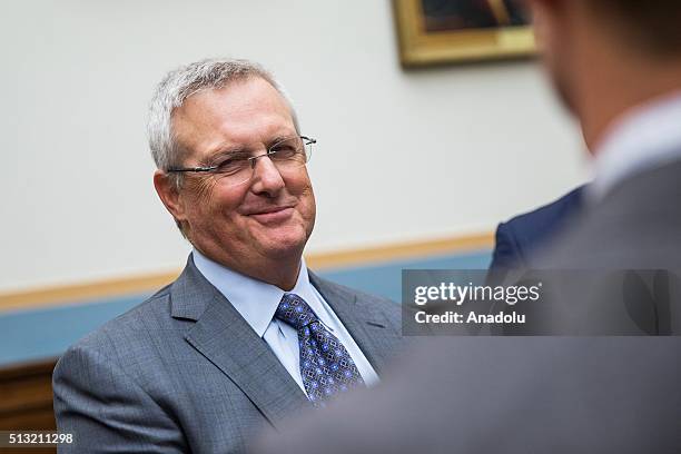 Apples General Council Bruce Sewell talks with colleagues in the chambers before testifying at a House Judiciary Committee Hearing on Apple's denial...