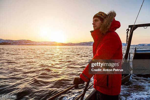 man in red jacket on board - commercial dock workers stock pictures, royalty-free photos & images