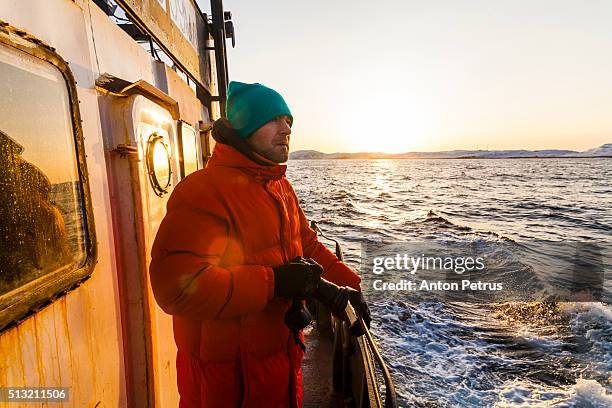 photographer on board of the fishing boat - trålare bildbanksfoton och bilder