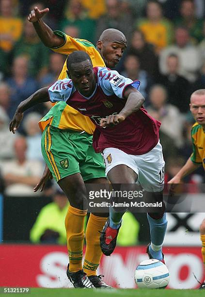 Carlton Cole slips the tackle of Damien Francis of Norwich during the Barclays Premiership match between Norwich City and Aston Villa on September...