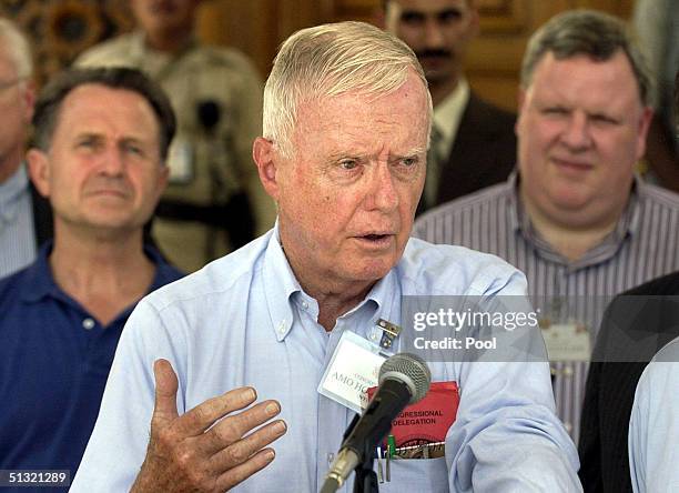 Rep. Amo Houghton speaks during a press conference as Rep. Wally Herger and Rep. Phil English listen September 18, 2004 in Baghdad, Iraq. The US...