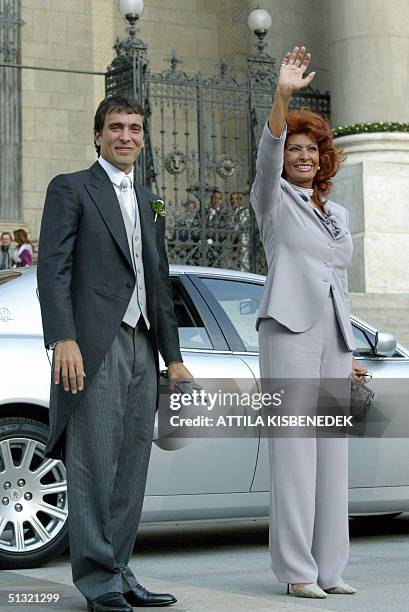 Italian actress Sophia Loren stands with her son Carlo Ponti as they wait to enter the Basilica in Budapest for the wedding of her son with Andrea...