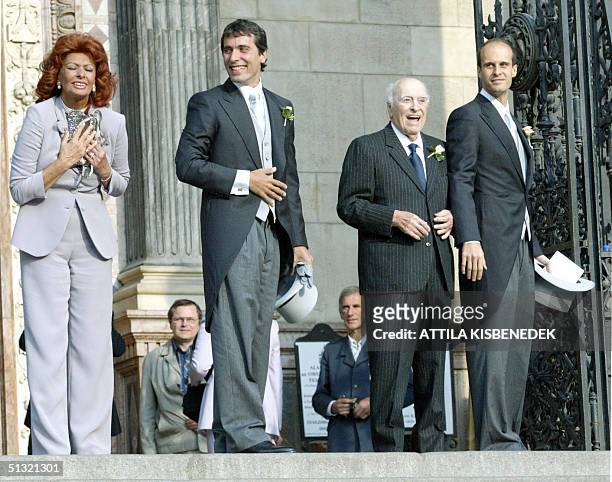 Sophia Loren, Carlo Ponti junior, Carlo Ponti and Eduard Ponti pose for the crowd in front of the Basilica in Budapest prior to the wedding of Carlo...