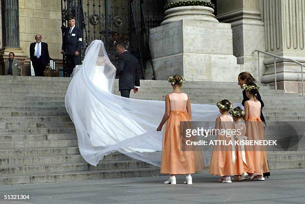 Hungarian bride Andrea Meszaros walks up the steps to the Basilica in Budapest where she is to marry Carlo Ponti, the son of Sophia Loren, 18...