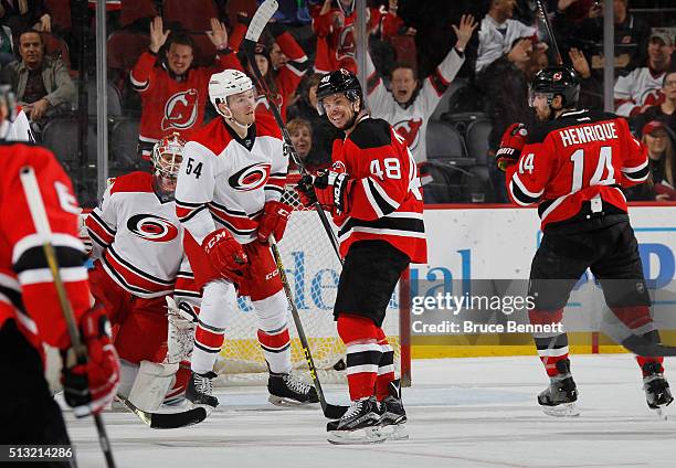 Tyler Kennedy of the New Jersey Devils celebrates a goal by Adam Henrique at 10:54 of the first period against the Carolina Hurricanes at the...