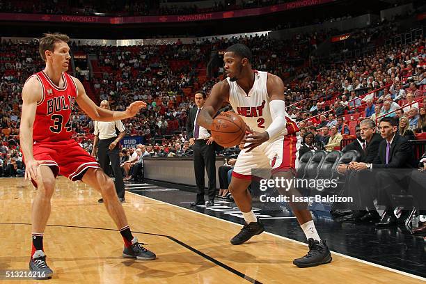 Joe Johnson of the Miami Heat moves the ball against Mike Dunleavy of the Chicago Bulls during the game on March 1, 2016 at American Airlines Arena...