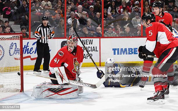 Craig Anderson of the Ottawa Senators watches the puck go past him for a power-play goal as team mates Cody Ceci and Dion Phaneuf look on and as...