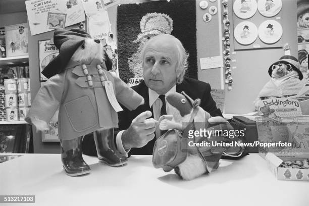 English author and creator of the Paddington Bear series of books, Michael Bond posed with a model of Paddington Bear in London on 18th June 1980.