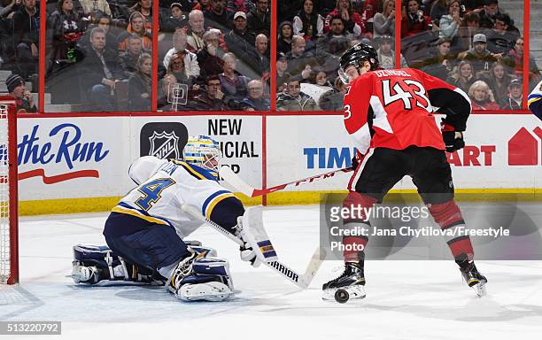 Jake Allen of the St. Louis Blues makes a stick save against Ryan Dzingel of the Ottawa Senators in the second period during an NHL game at Canadian...