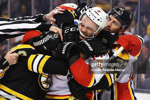 Brad Marchand of the Boston Bruins and Mark Giordano of the Calgary Flames fight during the third period at TD Garden on March 1, 2016 in Boston,...