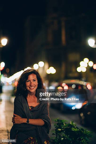 pretty smiling woman in the street at night - einzelne frau über 30 stock-fotos und bilder