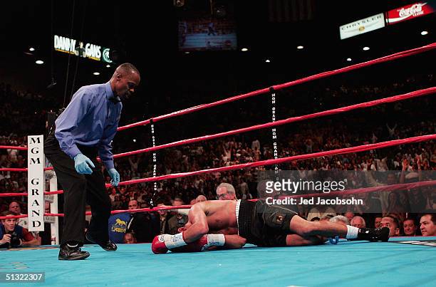 Referee Kenny Bayless approaches Oscar De La Hoya after he was knocked out by Bernard Hopkins for the world middleweight title at the MGM Grand...