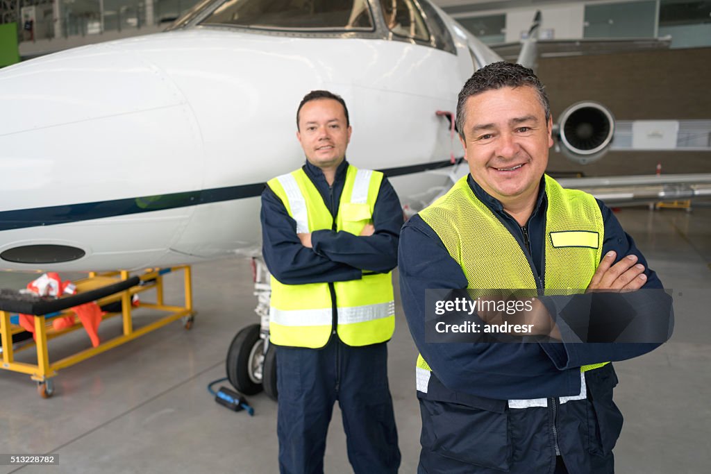 Mechanics working at an airplane hangar